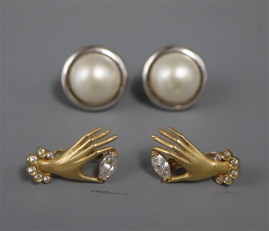 A pair of 750 yellow metal hand earrings and a pair of 9ct. and mabe pearl earrings.